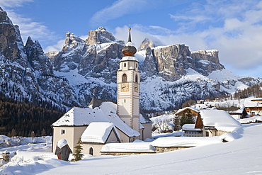 The church and village of Colfosco in Badia, 1645, and Sella Massif range of mountains under winter snow, Dolomites, South Tirol, Trentino-Alto Adige, Italy, Europe