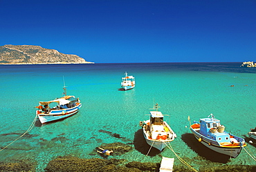 Fishiing boats and man snorkelling at Anopi Beach, Karpathos, Dodecanese, Greek Islands, Greece, Europe