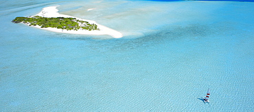 Catamaran sailing near a desert island, the Maldives, Indian Ocean