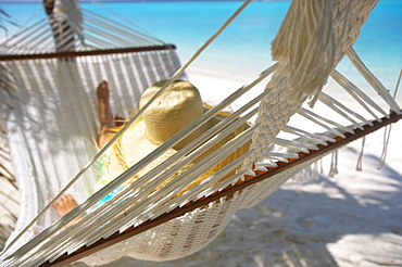 Woman relaxing in a hammock, Maldives, Indian Ocean, Asia