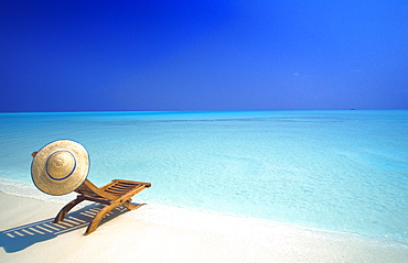 Wooden deckchair and hat on tropical beach, Maldives, Indian Ocean, Asia