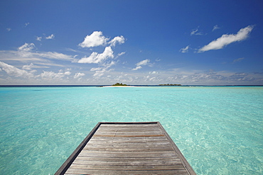 Wooden jetty and tropical sea, view from island, Maldives, Indian Ocean, Asia
