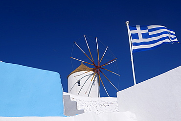 Church, windmill and Greek flag, Santorini, Cyclades, Greek Islands, Greece, Europe