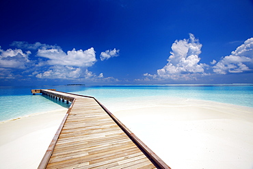 Wooden jetty out to tropical sea, Maldives, Indian Ocean, Asia