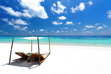 Lounge chairs on tropical white sandy beach, The Maldives, Indian Ocean, Asia