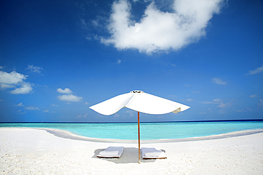 sunbed and umbrella on tropical beach in the Maldives