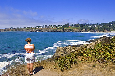 Woman on clif overlooking California's picturesque Mendocino coast, California, United States of America, North America