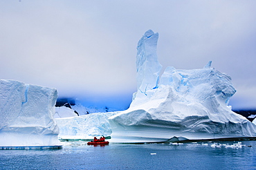 Passengers exploring icebergs near PlŽneau Island, Antarctica, Polar Regions