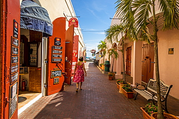 Woman walking by shop in downtown Charlotte Amalie, St. Thomas, US Virgin Islands, Caribbean