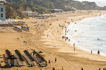 Beachgoers and umbrellas at Praia dos Pescadores or Fishermans Beach, Albufeira, faro district, algarve, portugal, europe.