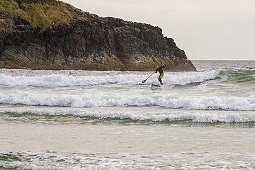 paddleboarding at Wickaninnish Beach, Pacific Rim National Park Reserve, Vancouver Island, British Columbia, Canada.