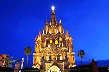 Mexico, Bajio, San Miguel de Allende , La Parroquia de San Miguel Arcangel neo-gothic exterior illuminated at night.