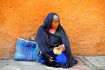 Mexico, Bajio, San Miguel de Allende, Woman begging on street corner.