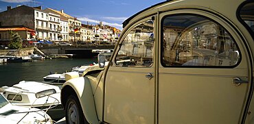 FRANCE Herault Sete.  Part view of harbour and waterside buildings with white citroen car in the foreground.