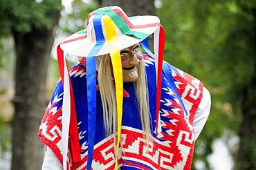 Mexico, Michoacan, Patzcuaro, Dancer in mask and costume performing Danza de los Viejitos or Dance of the Little Old Men in Plaza Vasco de Quiroga.