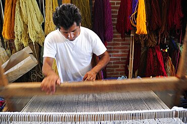 Mexico, Oaxaca, Teotitlan del Valle , Weaver at loom.