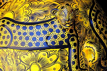 Mexico, Oaxaca, Detail of ceramic pot depicting spotted big cat in black and yellow.