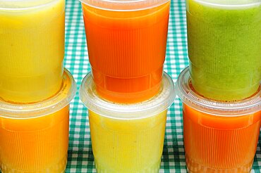 Mexico, Bajio, Guanajauto, Yellow green and orange jugos or fruit juices.