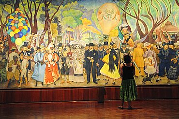 Mexico,  Federal District, Mexico City, Visitor looking at Dream of a Sunday Afternoon in the Alameda mural by Diego Rivera in the Museo Mural Diego Rivera.