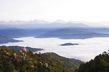 Nepal, Nagarkot, View across clouded valley towards Himalayan mountains.