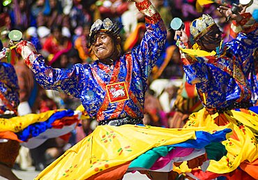 Bhutan, Thimpu Dzong, Dancers in the courtyard during festival.