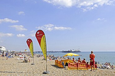 England, East Sussex, Brighton, Lifeguards on the beach.