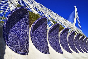 Spain, Valencia Province, Valencia, La Ciudad de las Artes y las Ciencias, City of Arts and Sciences, Arches of the Umbracle sculpture garden with El Pont de l'Assut de l'Or bridge in the background.