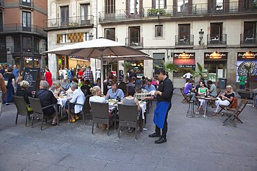 Spain, Catalonia, Barcelona, Cafe with tourists sat outside in La Ribera.