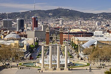 Spain, Catalunya, Barcelona, Placa d'Espanya and general vista towards Tibidabo mountain with Venetian Towers and Arenas de Barcelona bullring prominent in the central area.