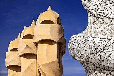 Spain, Catalunya, Barcelona, Antoni Gaudi's La Pedrera building, a section of chimney pots on the roof terrace.