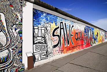 Germany, Berlin, The East Side Gallery, a 1.3 km long section of the Berlin Wall, Mural known as Save our Earth by Artist Indiano.