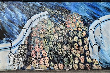 Germany, Berlin, The East Side Gallery, a 1.3 km long section of the Berlin Wall, Mural known as Ã¢â‚¬ËœIt happened in NovemberÃ¢â‚¬â„¢ by Kani Alavi.