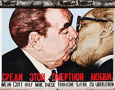 Germany, Berlin, The East Side Gallery, a 1.3 km long section of the Berlin Wall, Mural called My God help me survive this deadly love, Soviet Premier Brezhnev kisses East German Chancellor Honecker.