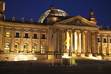 Germany, Berlin, Mitte, Reichstag building with glass dome deisgned by Norman Foster, illuminated at night.