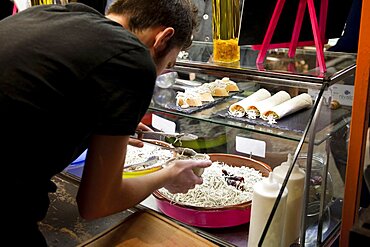 Spain, Madrid, Mercado de San Miguel, serving up elvers.