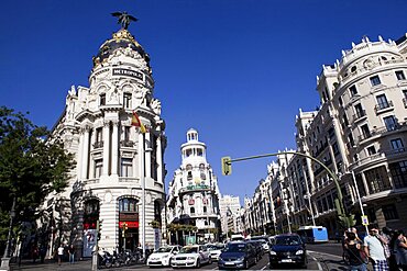 Spain, Madrid, Busy traffic on Alcala Grand Via junction next to the Metropolis building.