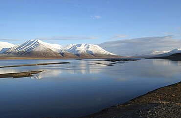 Norway, Svalbard, Longyearbyen, View across Adventfjorden toward snow capped mountain.