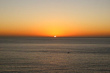 Malta, Sliema, Mediterranean sunrise and small fishing boat.