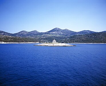 CROATIA  Dalmatia View over water toward small islet between Sibenik and Trogir with lighthouse in the centre  Center   Center