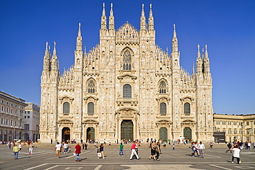 Italy, Lombardy, Milan. Milan Duomo or Cathedral, General view of the facade with tourists in the piazza out front.