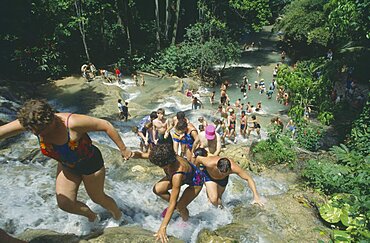 WEST INDIES Jamaica Ocho Rios Tourists helping each other up to the top of Dunns River Falls