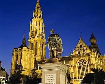 BELGIUM Flemish Region Antwerp Cathedral of Notre Dame with statue of the seventeenth century artist Peter Paul Rubens in the foreground illuminated at night. Cathedral of Our Lady