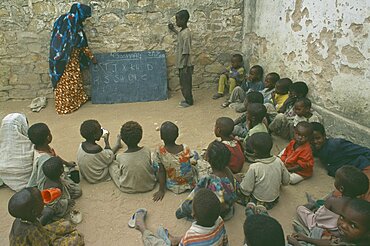 SOMALIA  Baidoa Teacher with pupils in outdoor classroom at school in Baidoa orphanage.