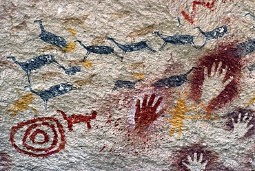 ARGENTINA Patagonia Cueva de las Manos Cave of the Hands.  Prehistoric rock paintings of human hands and animals in red black and orange 13 000 to 9 500 years old.