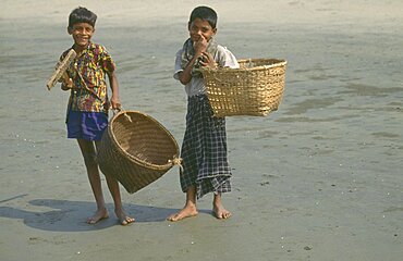 BANGLADESH  Children Two young boys carrying large woven baskets.