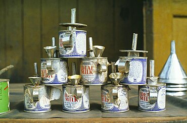 GHANA  Tarkwa Nestle evaporated milk cans made into oil lamps. recycle recycling