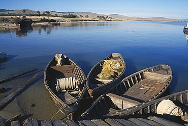 RUSSIA Lake Baikal Wooden fishing boats moored beside wooden jetty.