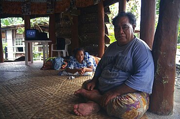 PACIFIC ISLANDS Western Samoa A Western Samoan tribal chief or Matai sitting on matting on floor inside house with television behind.