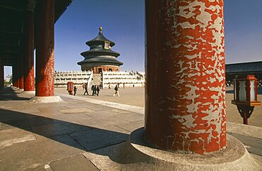 CHINA  Beijing Temple of Heaven.  Hall of Prayer for Good Harvests through colonnade of pillars with peeling red paint.   Peking