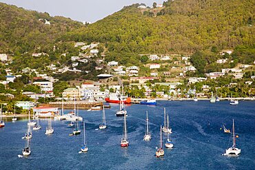 WEST INDIES St Vincent & The Grenadines Bequia Port Elizabeth with yachts moored in Admiralty Bay with the ferry port and hillside housing beyond